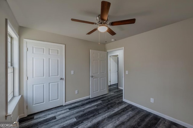 unfurnished bedroom featuring dark wood-style floors, ceiling fan, and baseboards