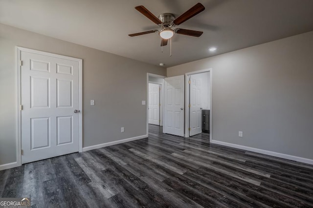 unfurnished bedroom featuring ceiling fan, baseboards, and dark wood finished floors