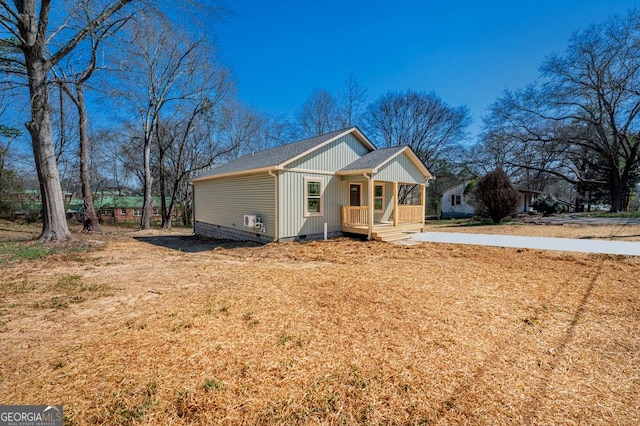 view of front of home with crawl space, covered porch, and roof with shingles