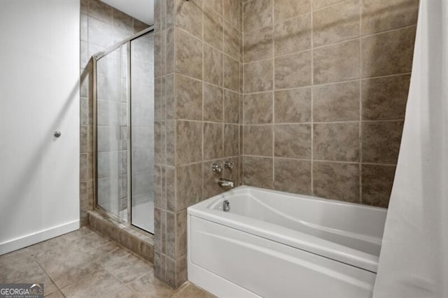 bathroom with tile patterned floors and independent shower and bath