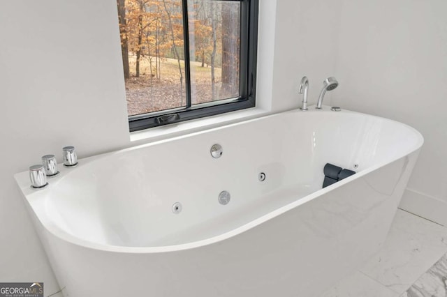 bathroom with a soaking tub