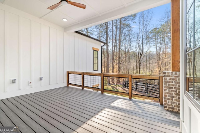 wooden deck featuring ceiling fan