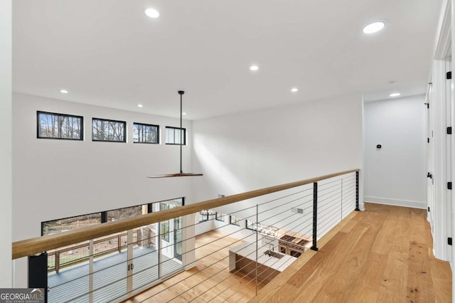 hall with light wood finished floors, recessed lighting, and baseboards