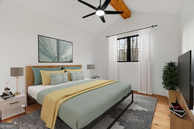 bedroom featuring baseboards, vaulted ceiling with beams, a ceiling fan, and wood finished floors