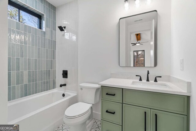 bathroom featuring vanity, shower / tub combination, and toilet