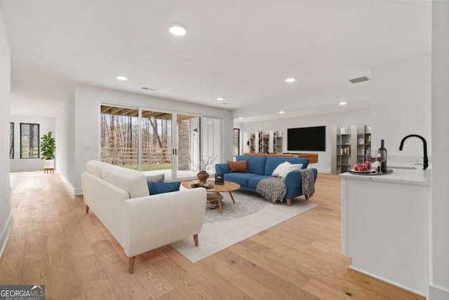 living area with recessed lighting and light wood-type flooring