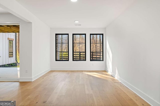 unfurnished room with recessed lighting, baseboards, and light wood-style floors