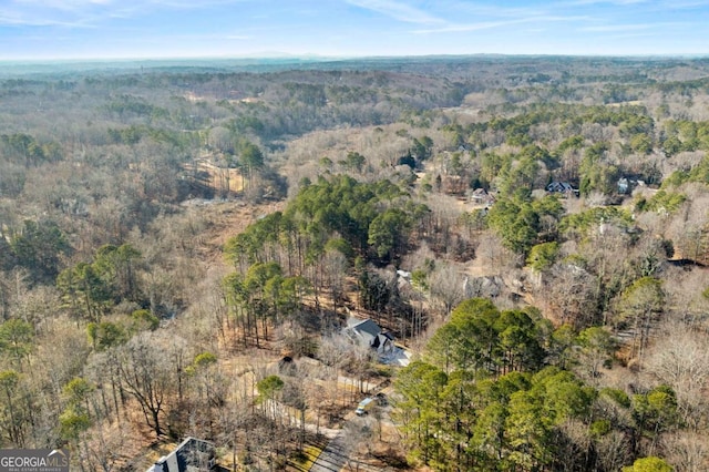 drone / aerial view featuring a wooded view