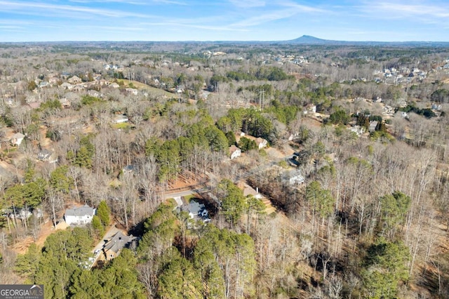 drone / aerial view with a wooded view