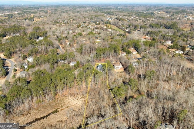 birds eye view of property with a view of trees