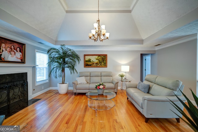 living room featuring lofted ceiling, a tiled fireplace, and ornamental molding