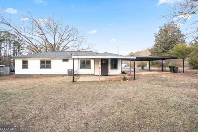 view of front of property with central AC unit, a front lawn, and a carport