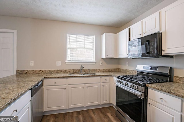 kitchen with sink, a textured ceiling, appliances with stainless steel finishes, and white cabinetry