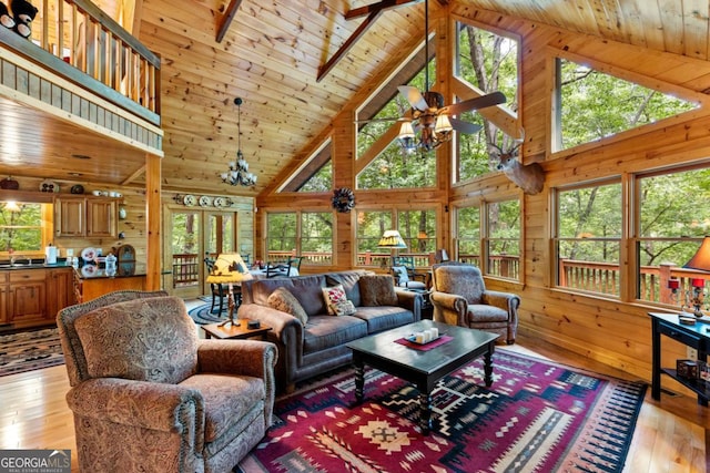 living room with high vaulted ceiling and light wood-type flooring