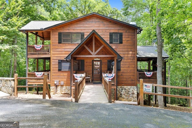 view of front of property featuring a balcony and covered porch