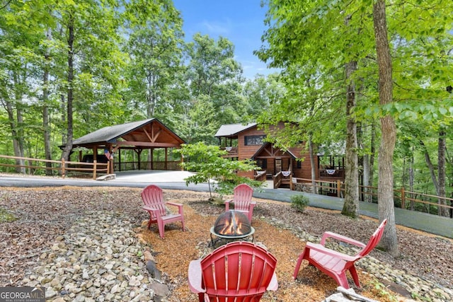 surrounding community with a gazebo and a fire pit