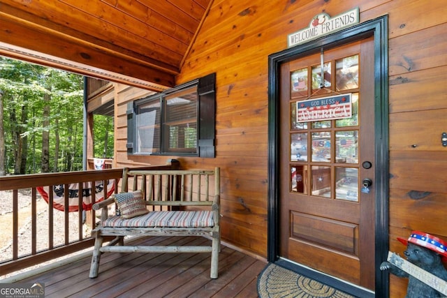 view of exterior entry featuring covered porch