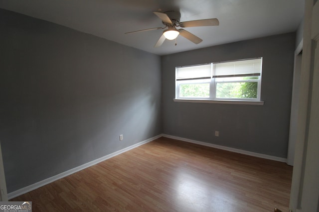 spare room featuring ceiling fan and light hardwood / wood-style flooring