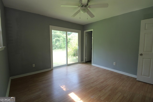 spare room featuring hardwood / wood-style floors and ceiling fan