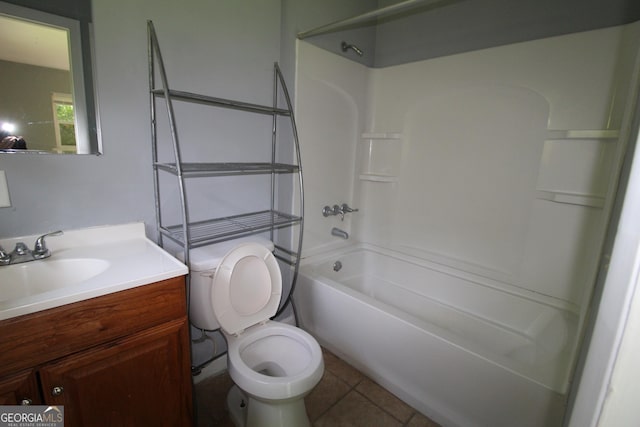 full bathroom featuring toilet, vanity, tile patterned flooring, and bathing tub / shower combination