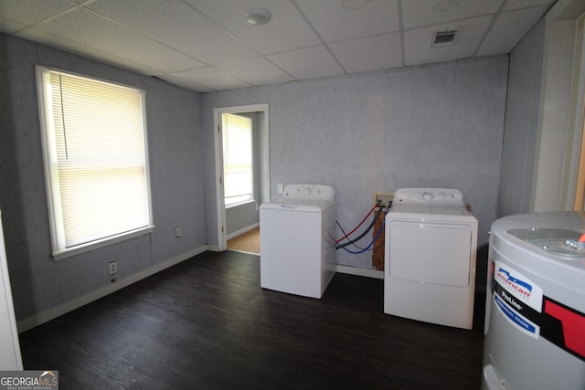 laundry room with washer and dryer, water heater, and dark hardwood / wood-style flooring