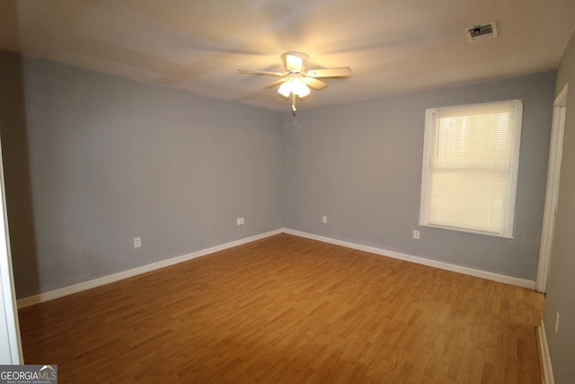 unfurnished room with ceiling fan and wood-type flooring