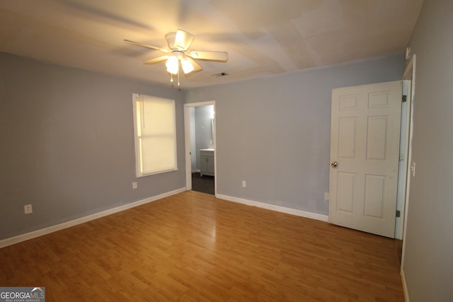 empty room with wood-type flooring and ceiling fan