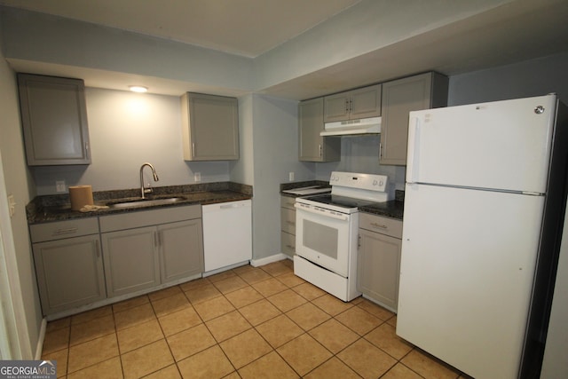 kitchen featuring white appliances, gray cabinetry, sink, and light tile patterned floors