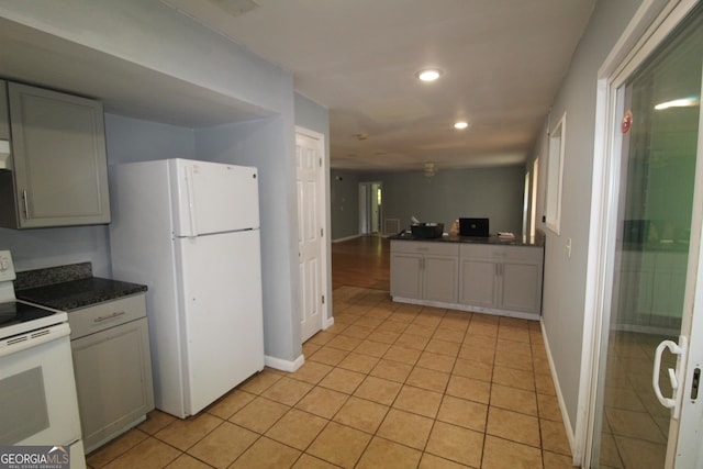 kitchen featuring white appliances and light tile patterned floors