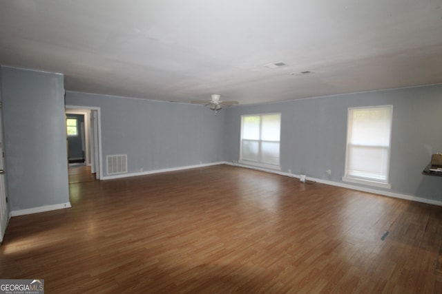 spare room featuring ceiling fan and dark hardwood / wood-style floors