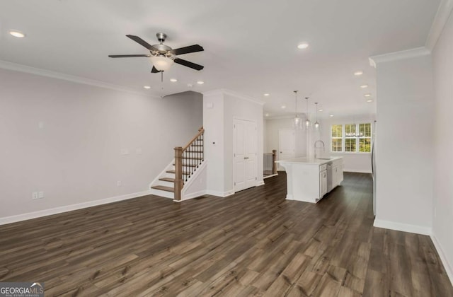 1708 Evenstad Way, Smyrna, GA 30080 - unfurnished living room with ornamental molding, a ceiling fan, recessed lighting, dark wood finished floors, and stairs