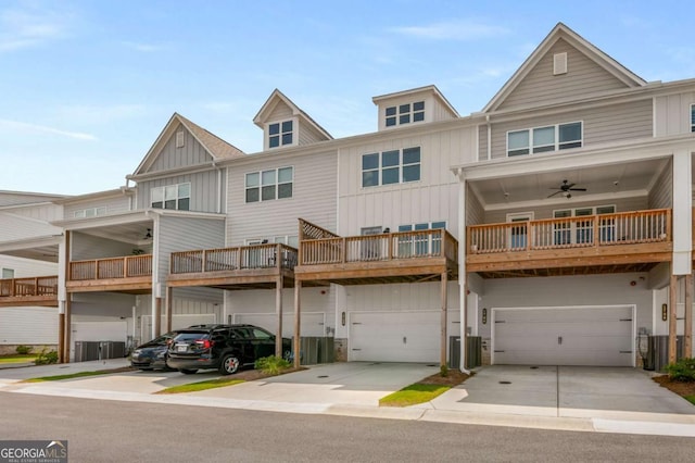 multi unit property featuring cooling unit, ceiling fan, and a garage