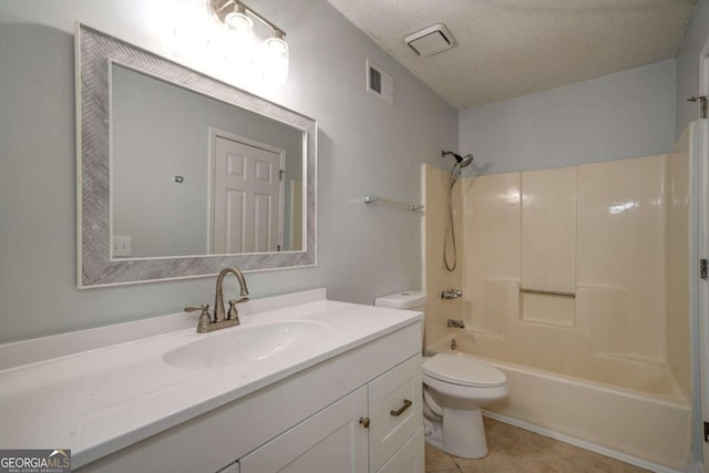 full bathroom with vanity, a textured ceiling, tile patterned flooring, toilet, and shower / washtub combination