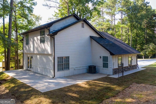 view of home's exterior with central air condition unit, a patio area, and a lawn