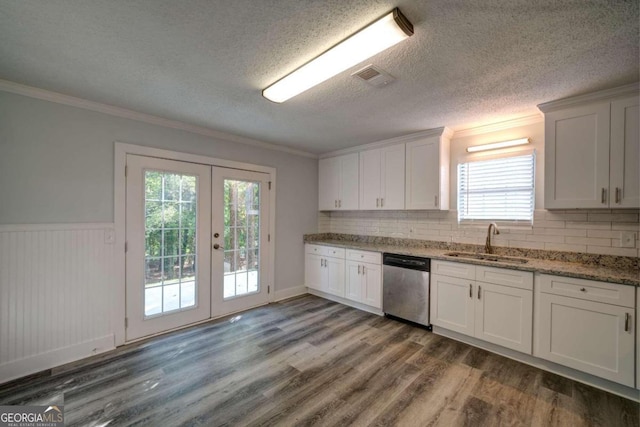 kitchen featuring sink, white cabinetry, french doors, stainless steel dishwasher, and stone countertops