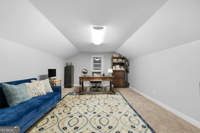 office space featuring light colored carpet and vaulted ceiling