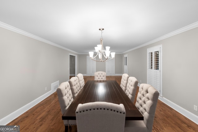 dining area with ornamental molding, a notable chandelier, and dark hardwood / wood-style flooring