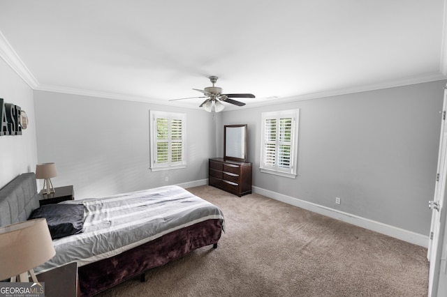 carpeted bedroom with ornamental molding and ceiling fan