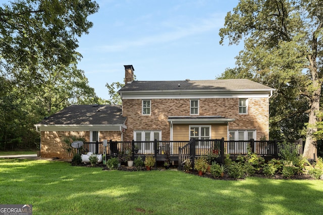 back of house featuring a deck and a lawn