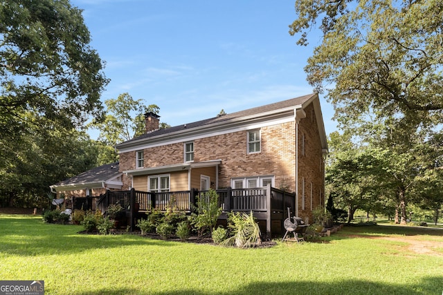 back of house with a yard and a wooden deck