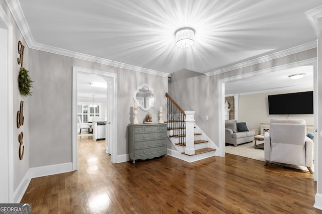 living room featuring ornamental molding, dark hardwood / wood-style flooring, and a chandelier