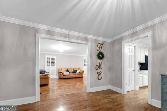 interior space with crown molding and wood-type flooring