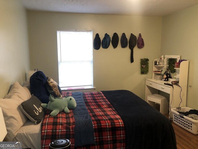 bedroom featuring a textured ceiling and multiple windows