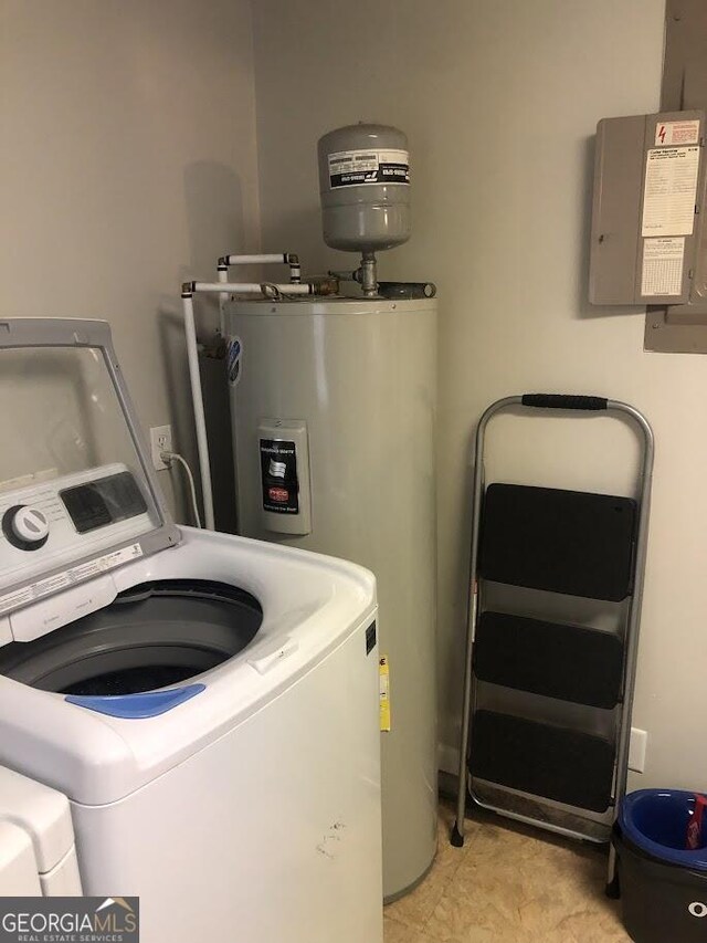 washroom with electric water heater and separate washer and dryer