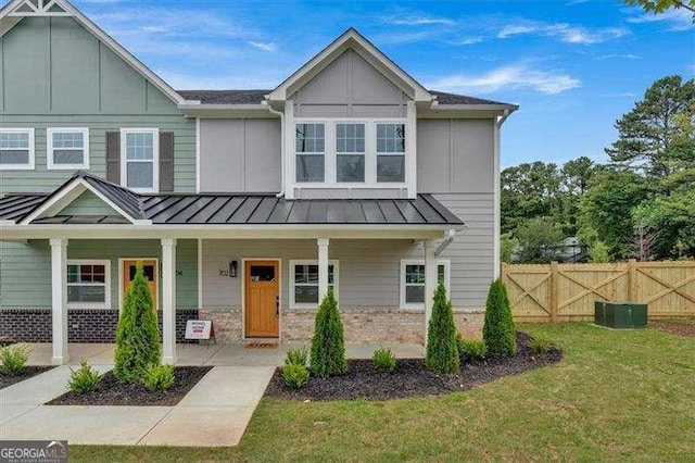 view of front of home with a porch and a front lawn