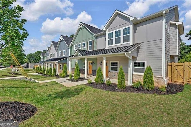 view of front of house with a porch and a front yard