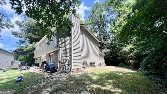 view of property exterior with a yard