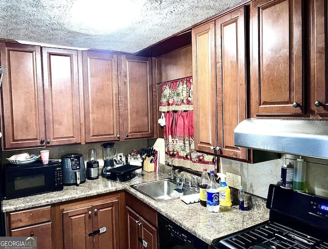 kitchen featuring light stone countertops, a textured ceiling, black appliances, and sink