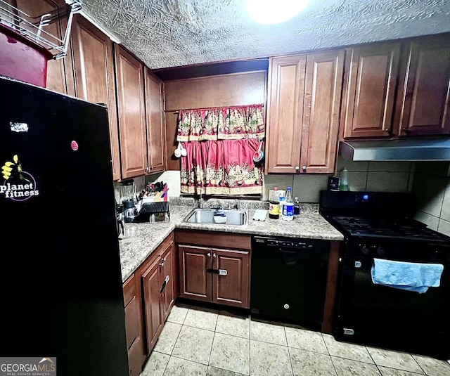 kitchen with a textured ceiling, black appliances, tasteful backsplash, light tile patterned flooring, and sink