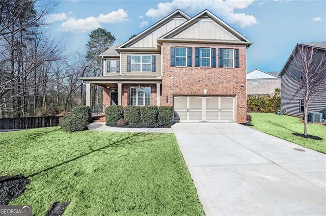 view of front facade featuring central AC unit, a front lawn, and a garage